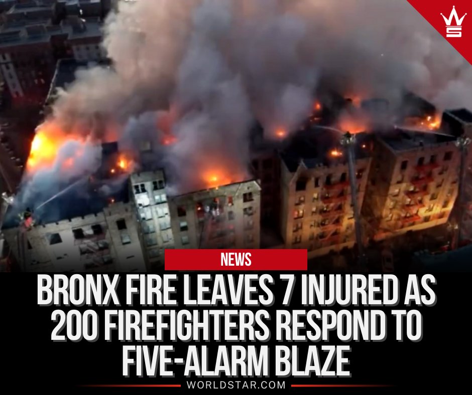 WORLDSTAR's tweet image. Nearly 200 firefighters are battling a massive 5-alarm fire at a Bronx apartment building, leaving at least 7 injured. Flames quickly spread due to strong winds, engulfing the roof.
