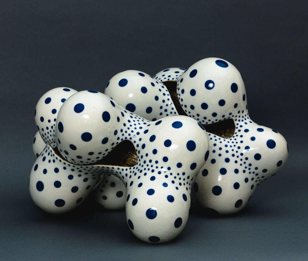 Inspired by the blue underglaze patterns of traditional Japanese porcelain, Harumi Nakashima puts his own twist on the technique by decorating his biomorphic porcelain sculptures with blue dots in varying sizes. 

This piece is on display at Racine Art Museum through January 11.