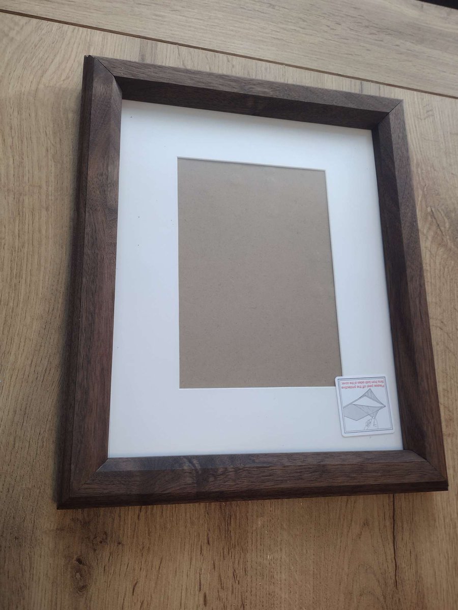 Walnut and cherry picture frames I made for a wedding gift. Ash corner splines made from wood from my property.