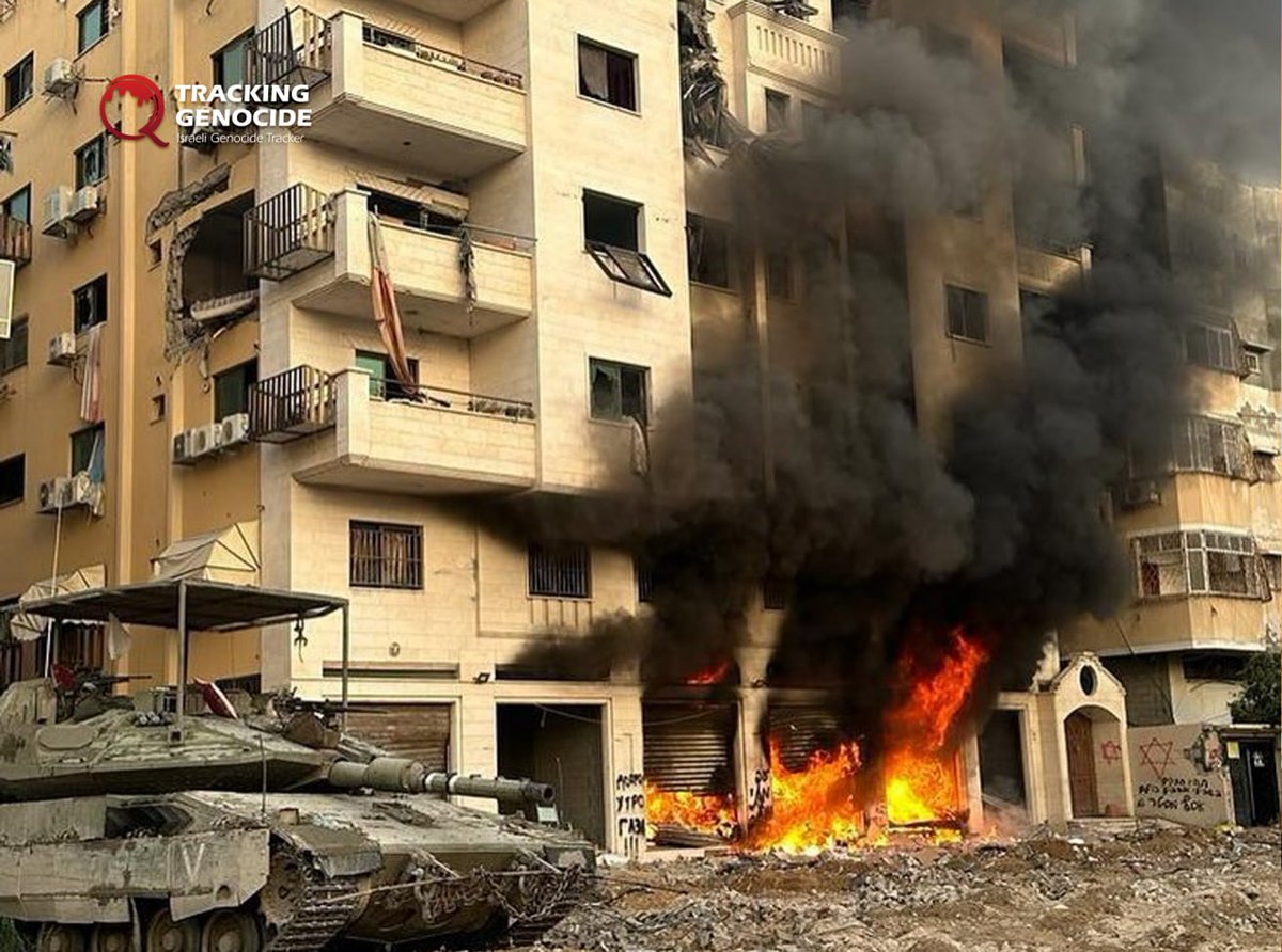 Israeli soldiers from the 52nd Armored Battalion posed in front of shops and residential towers they set ablaze during their invasion of Gaza City.