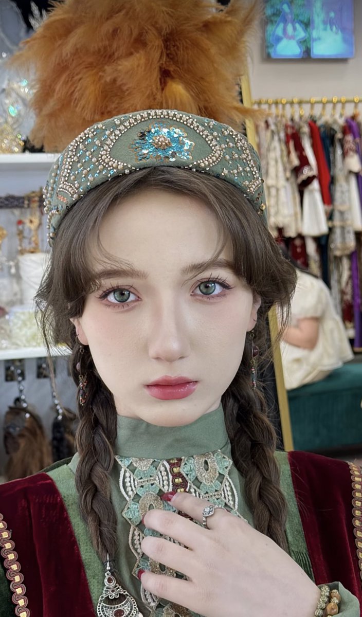 Saukele is a traditional Kazakh bridal headdress that symbolizes the bride’s transition into a new life through marriage. Typically made from luxurious fabrics such as silk or velvet, it is adorned with gold, silver, pearls, coral, and traditional motifs. The conical, often tall shape of the Saukele is crowned with feathers, such as those of an eagle or swan, symbolizing strength and purity. Completing the look with accessories, this headdress reflects both the bride’s and her family’s social status, while also carrying protective symbols to ward off evil spirits. As one of the most important elements of Kazakh weddings, the Saukele continues to play a significant cultural and symbolic role.