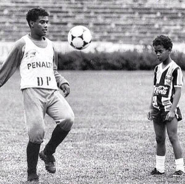 90sfootball's tweet image. A young Ronaldinho learning to play football with his older brother.