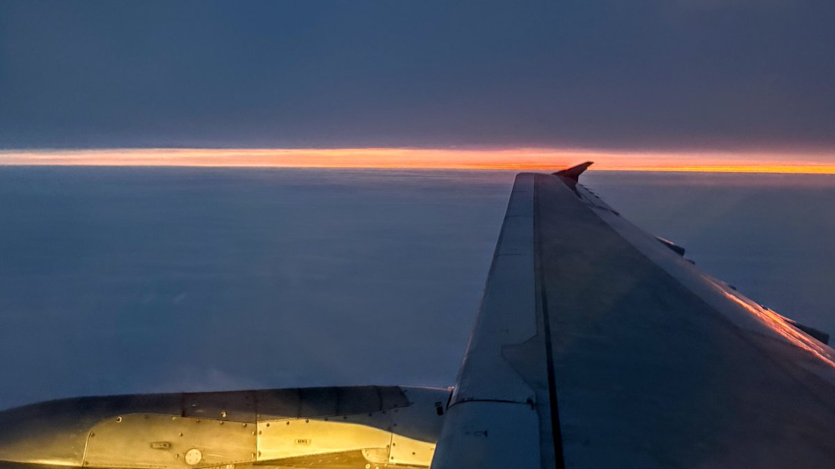 carmilevy's tweet image. As we cruise between the clouds, the rising sun decides to paint the distant horizon in shades of orange/salmon that no camera could ever hope to accurately capture.

Moments like this happen but once. We owe it to ourselves to look out the window when they do.

#yyz #ywg