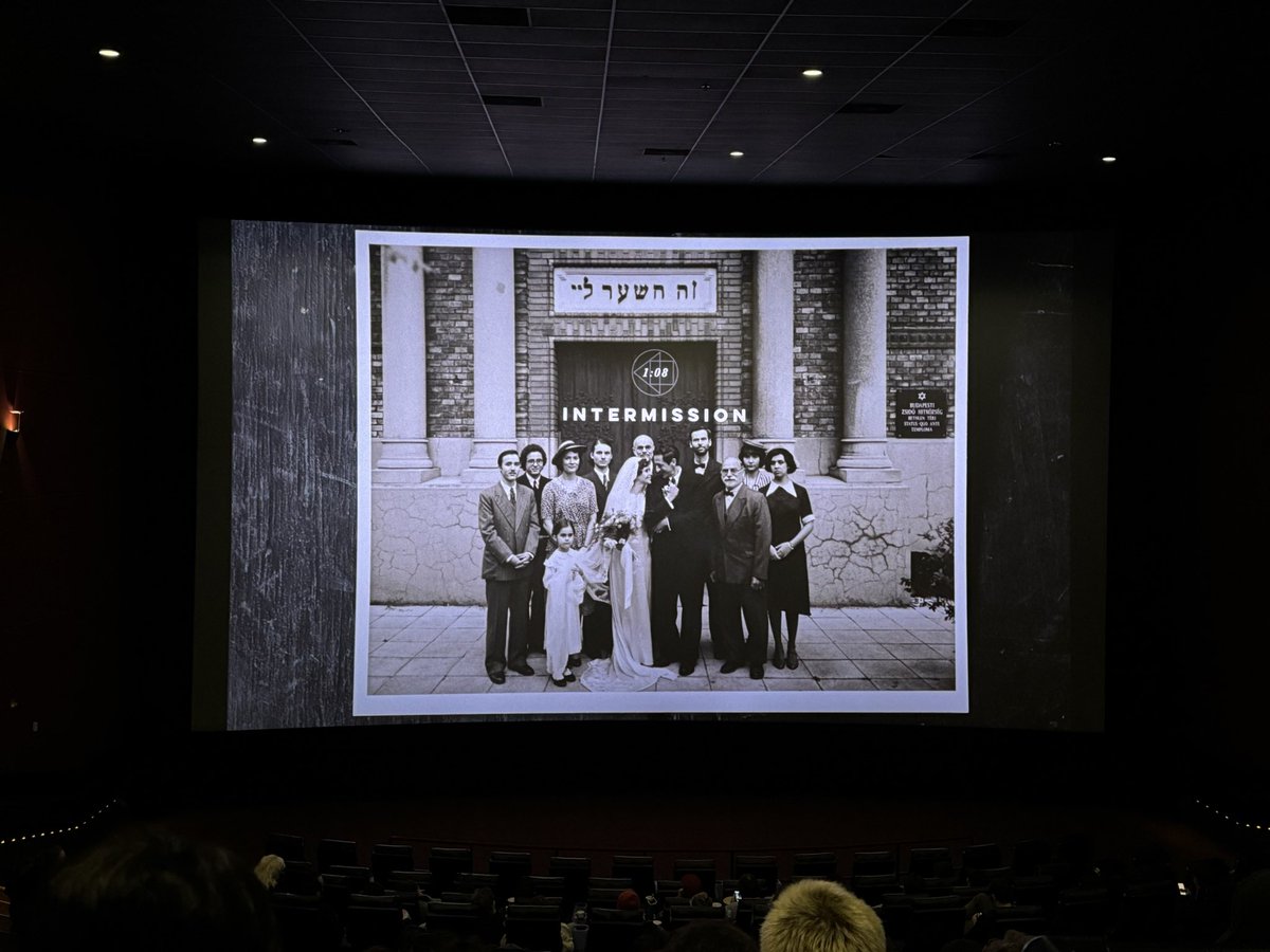 e_ms's tweet image. I saw The Brutalist in 70mm film. During the intermission when changing reels, there was an issue with the projector so they played part 2 in digital. Here is the difference between the two on the intermission screen. Cool to see.