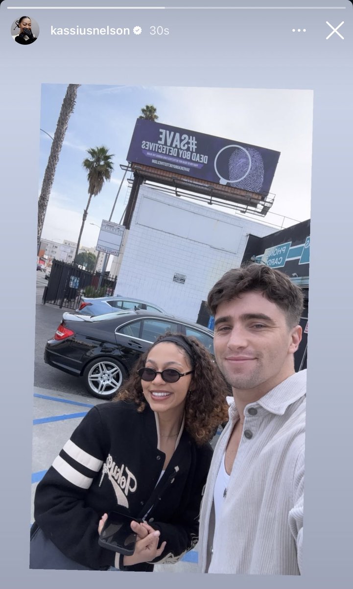 dbdagency's tweet photo. Kassius and George at Our Save Dead Boy Detectives Billboard! 🎉💜
#SaveDeadBoyDetectives
#DeadBoyDetectives https://t.co/hVRnmzELyk