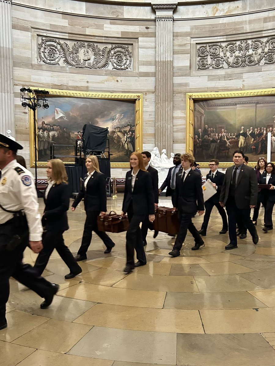 Senate pages, all 16 or 17 years old, carry the mahogany vote boxes from the Senate to the House chamber