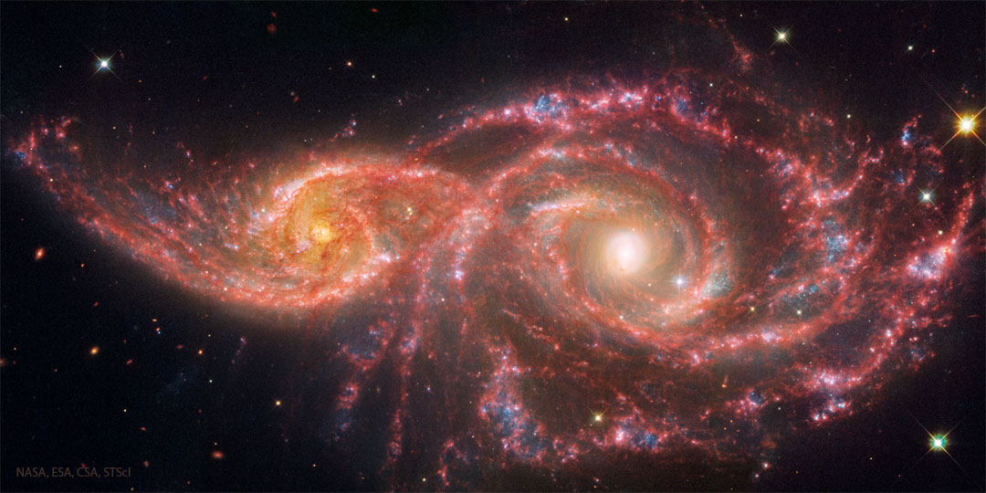 Billions of years from now, only one of these two galaxies will remain. 

Until then, spiral galaxies NGC 2207 and IC 2163 will slowly pull each other apart, creating tides of matter, sheets of shocked gas, lanes of dark dust, bursts of star formation, and streams of cast-away