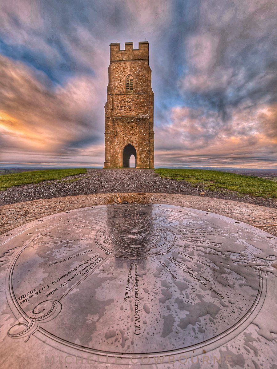 The compass stone and reflections on Glastonbury Tor.