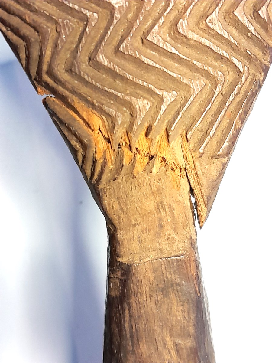 ConservationBob's tweet image. Ipswich Museum conservation. Oval decorated shield from Australasia. Terminal has broken. The terminal was re-attached with neutral acid free PVA in water. Gap filled with glass micro balloons in Paraloid B72.  Carefully rubbed down and retouched with water soluble paint.