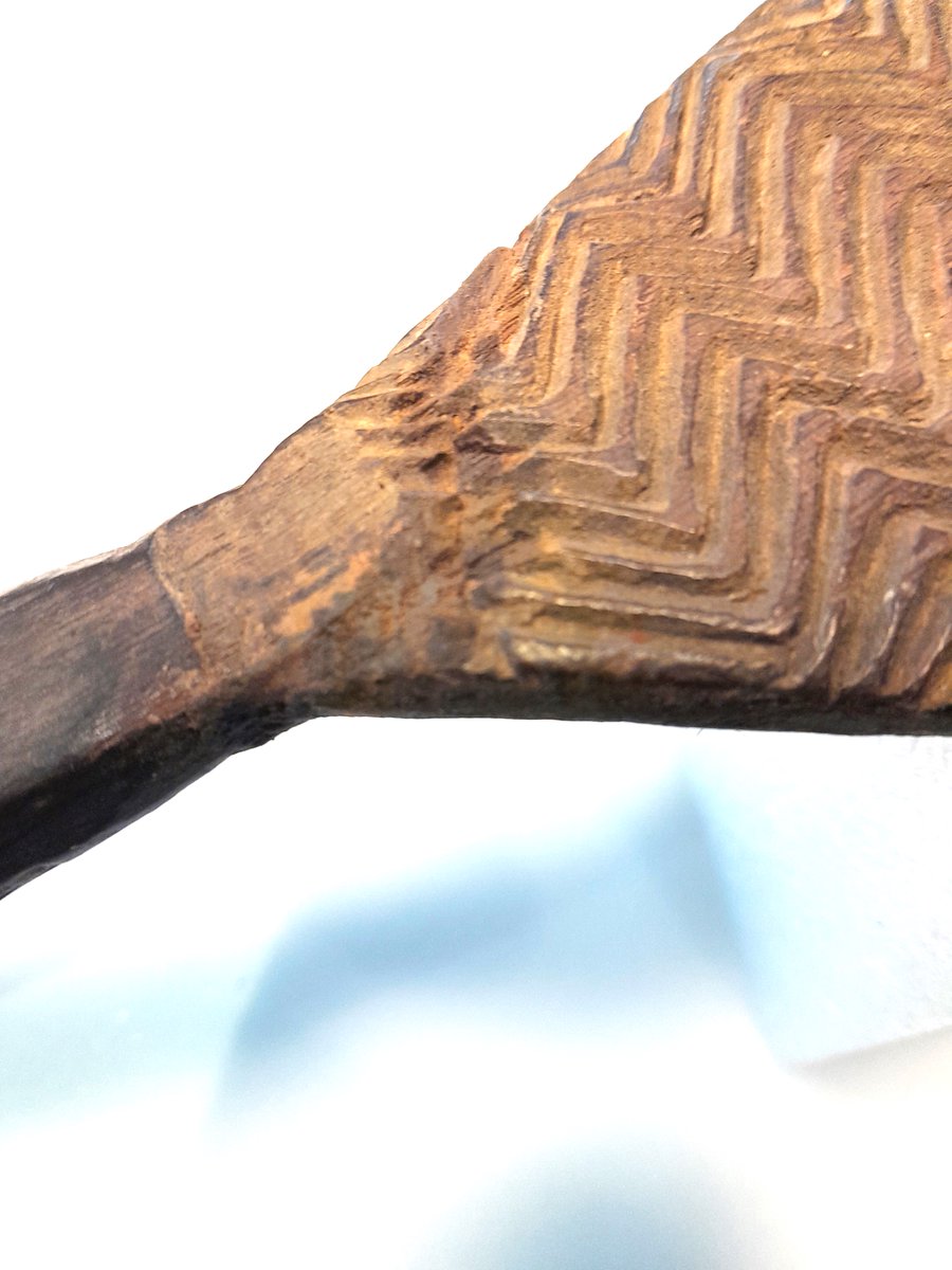 ConservationBob's tweet image. Ipswich Museum conservation. Oval decorated shield from Australasia. Terminal has broken. The terminal was re-attached with neutral acid free PVA in water. Gap filled with glass micro balloons in Paraloid B72.  Carefully rubbed down and retouched with water soluble paint.