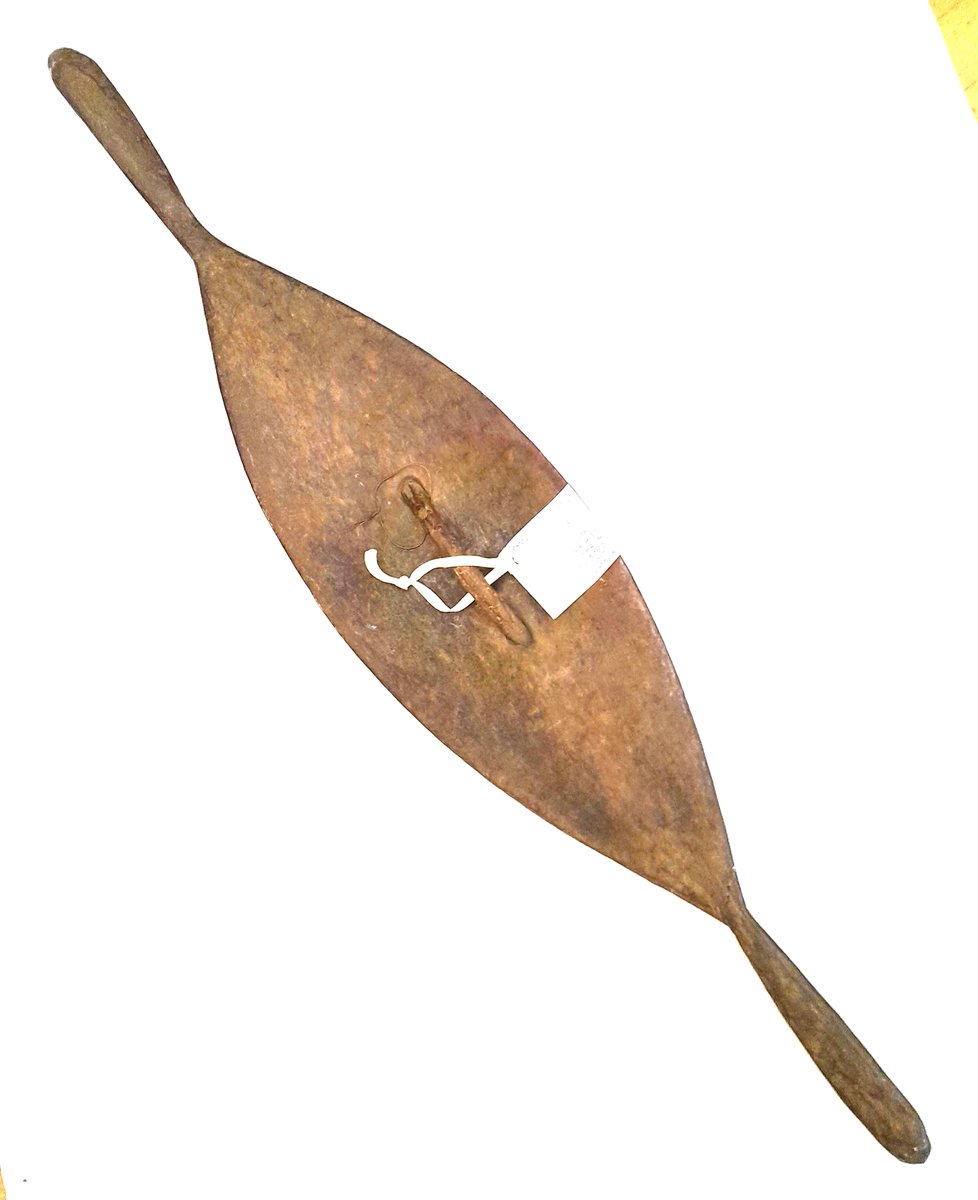 ConservationBob's tweet image. Ipswich Museum conservation. Oval decorated shield from Australasia. Terminal has broken. The terminal was re-attached with neutral acid free PVA in water. Gap filled with glass micro balloons in Paraloid B72.  Carefully rubbed down and retouched with water soluble paint.