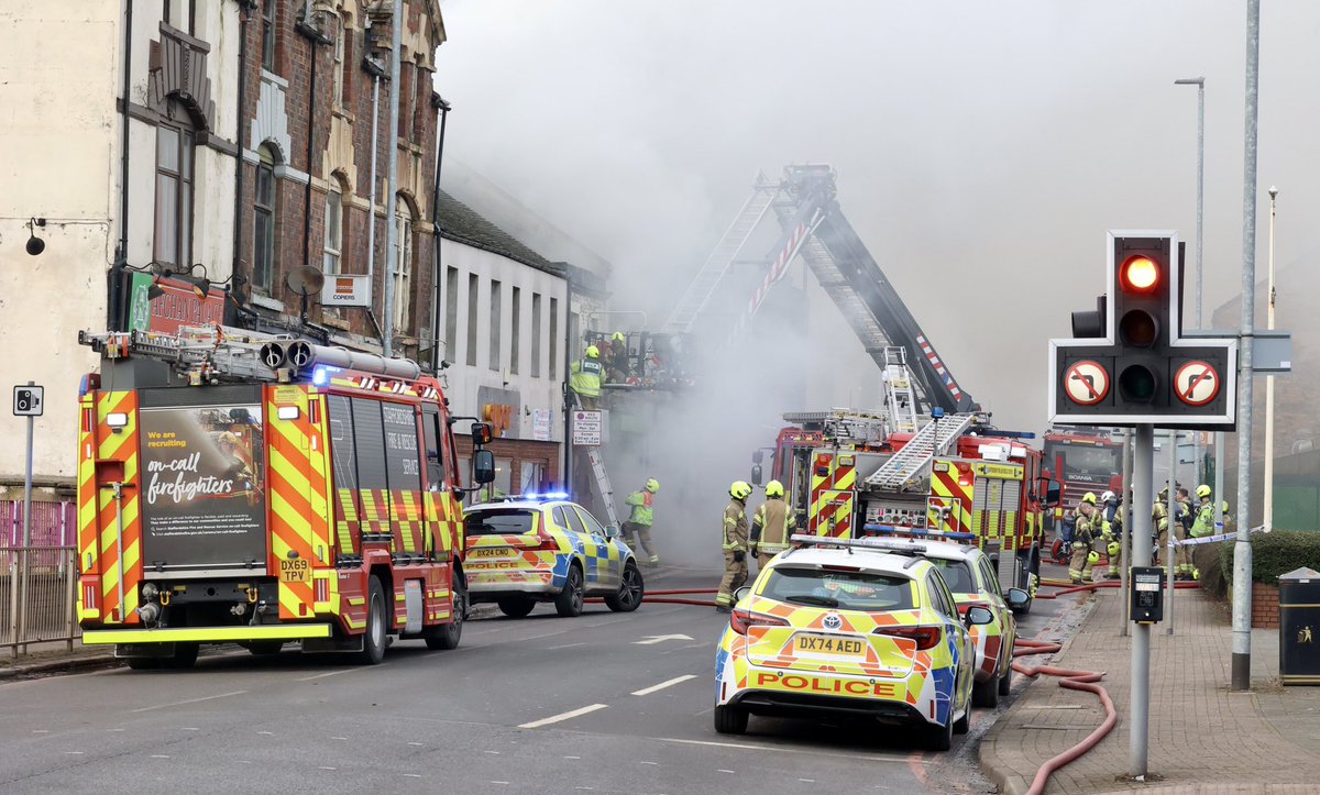 Firefighters rescue a group of people from a building in Burslem, Stoke-on-Trent as crews continue to tackling a blaze. An air ambulance has been seen hovering above Burslem as emergency services continue their efforts on Waterloo Road #stoke #stokeontrent