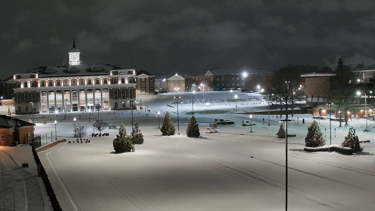 Jones Hall and surrounding area as night falls on snow day 2025 at Troy University.