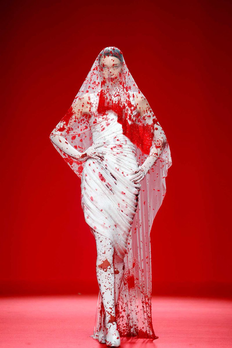 Robert Wun Haute Couture Spring/Summer 2024

If you look closer, the model's "blood"-stained gown and veil are intricately decorated with red jewel-like embellishments.