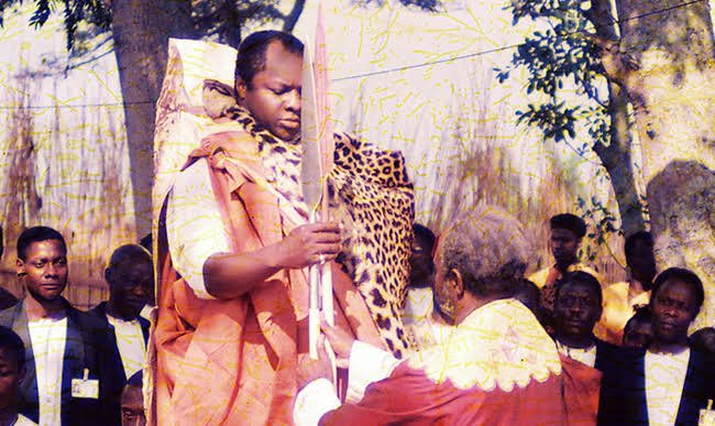 56Tribe's tweet photo. Key Cultural Sites at Naggalabi Coronation Site

Naggalabi is a revered cultural site in Buganda, steeped in traditions that mark the journey of a prince to kingship. Here are the key cultural places and their significance; 

Buganda House
This house is where the prince stays for several days in preparation for kingship. In the past, a king would spend 18 days here during a period called “Enaku z’obwerinde” (days of tension). During this time, all residents abstained from certain activities, including touching a woman, to honor the sacred process.

Bwanika House
The prince undergoes sacred rituals in this house, but before entering, he takes a cleansing ritual bath called “Akogero.” This act symbolizes purification and readiness for leadership.

Magato
At this spot, the prince is fitted with traditional sandals, a symbolic gesture that his feet are ready to undertake the duties of a king.

Nakibuuka
Further rituals are performed here, culminating in the prince being crowned and officially declared the king of Buganda.

Mboneredde Tree
This ancient tree is a treasured symbol of Buganda’s history. It is said that Kabaka Kintu, Buganda’s first king, used it as his court. People proven guilty during court sessions would plead for forgiveness under its shade, saying “Mboneredde” (I have learned my lesson), giving the tree its iconic name.

#tribe56