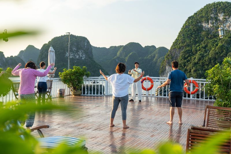 IndochinaSails's tweet photo. Let the gentle movements of Tai Chi guide you into a state of calm and balance, surrounded by the breathtaking beauty of Vietnam's most iconic heritage site. This peaceful activity on the open waters offers the perfect start to your day, bringing harmony between mind and body. https://t.co/ITRVcxvQVx