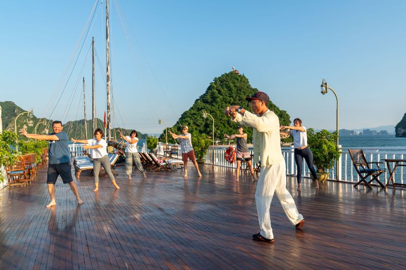 IndochinaSails's tweet photo. Let the gentle movements of Tai Chi guide you into a state of calm and balance, surrounded by the breathtaking beauty of Vietnam's most iconic heritage site. This peaceful activity on the open waters offers the perfect start to your day, bringing harmony between mind and body. https://t.co/ITRVcxvQVx