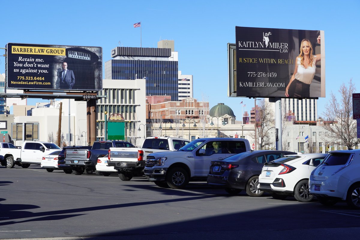OurTownReno's tweet photo. "Justice within reach" or "You don't want us against you," which lawyer has the better billboard ad and which one would you choose?  A sly knowing smile with a friendly pose or a stern look with hands in pockets? #stuffyouseeinreno #randomreno #lawyersofreno #attorneysofreno https://t.co/YXQkSIKvpI