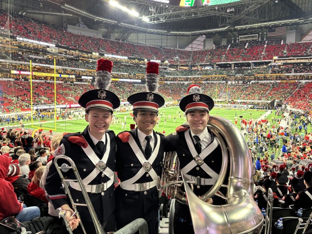 BishopWatterson's tweet photo. Our recent grads at the College Football National Championship Game with Ohio State's team and band! Congrats to Ryan Rudzinski '23, Lucia Cherok ’22, Julien Brandon ’24 and Sam George ’17! 🦅❤️ https://t.co/zBdUe5mXAC