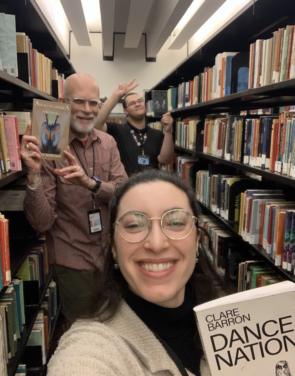 nypl's tweet image. Need a pick-me-up? It's #LibraryShelfieDay! NYPL staff are sharing some library joy posing in front of their favorite bookshelves. Snap a photo of yourself in front of your bookshelf at home or at your local library 🤳