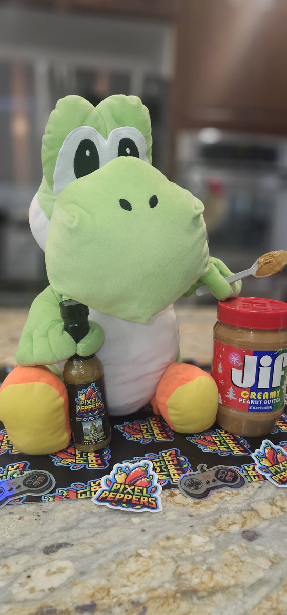 Happy National Hot Sauce Day! 🔥 Yoshi’s spicing it up with peanut butter and Green Inferno—an unexpected combo that brings the heat! How are you celebrating today? Turn up the heat with us:
 pixelpeppers.com/hot-sauce/gree… 🌶️ 

#NationalHotSauceDay #PixelPeppers