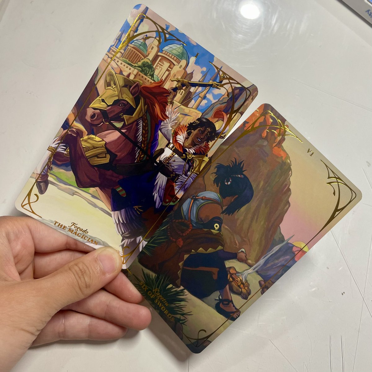 wheeee my contributor copy of <a href="/EngageArcana/">Emblem of the Arcana - Engage Tarot</a> arrived! everyone’s works look lovely and i can’t contain my excitement at seeing my illustrations printed as a part of this project 🥹🃏 fe engage forever… 🫡