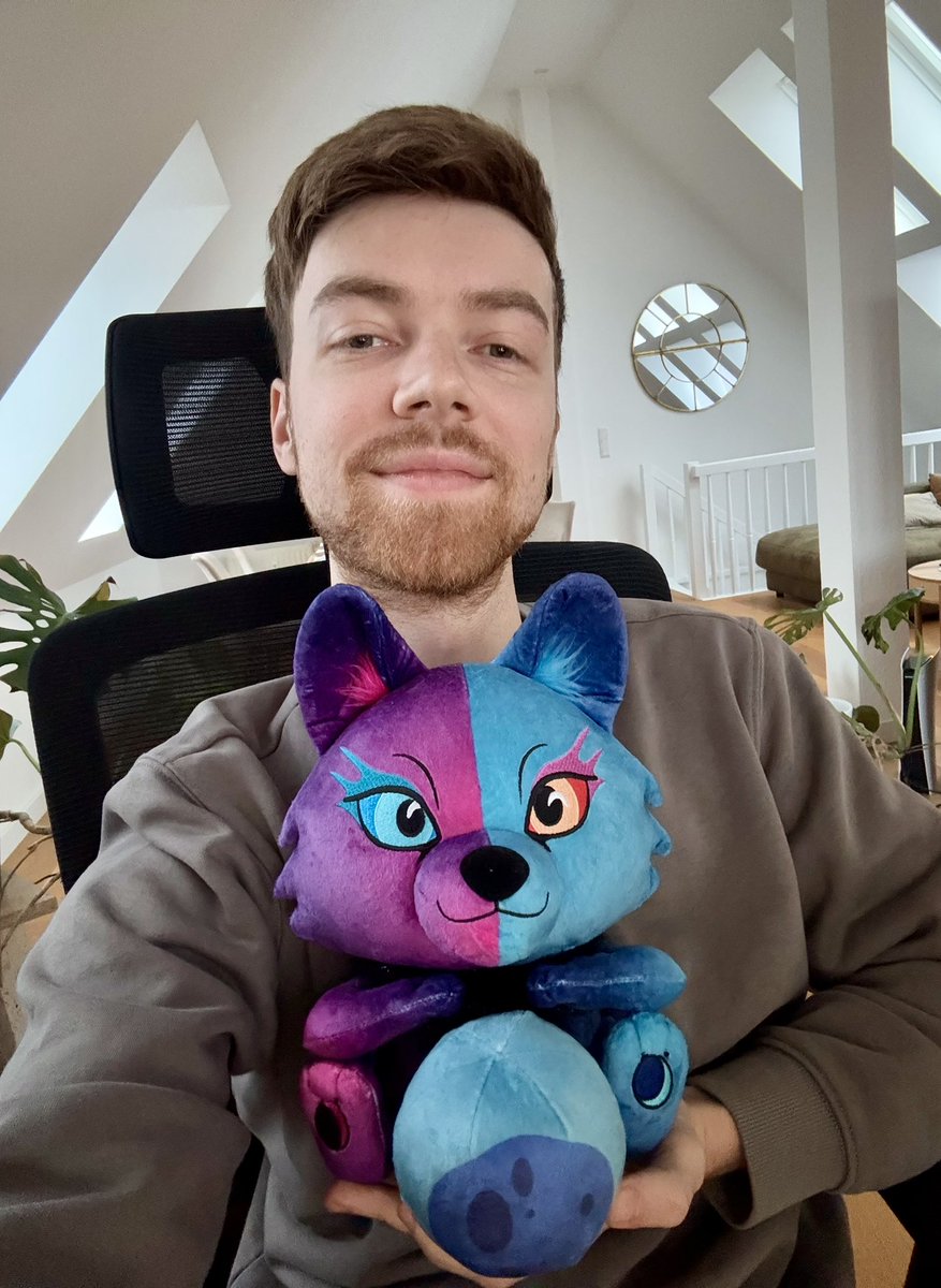 Me and Galaxy Wolf plushie in the apartment I bought by suing all the companies that stole my Galaxy Wolf painting.

The circle is complete 🫶🏻