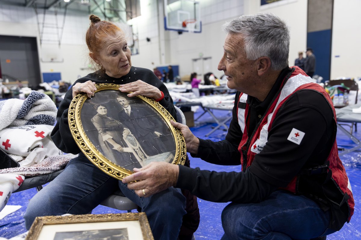 RedCross's tweet photo. She couldn't bear to leave the picture behind. 

“They were really something,” said Rona Schneider, a California resident who is staying at a Red Cross evacuation shelter due to the wildfires. The photo is of her mother and father — first-generation immigrants from Poland — taken decades ago.

Rona doesn't yet know if her home and car survived the fires, but our shelter workers and volunteers are taking care of everything she needs in the meantime. In fact, more than 200 American Red Cross workers, many of whom have been impacted by these wildfires themselves, are helping in southern California where hundreds of evacuees woke up in emergency shelters this morning. 

These fast-moving wildfires have scorched entire neighborhoods, leaving many with nothing but what they fled with. To make sure no one faces this heartbreaking crisis alone, we’re working closely with our partners to provide safe shelter, food, emotional support and other critical services.

If you need help: 

- Visit one of our shelters — you don’t have to stay overnight to get help. In shelters, disaster health volunteers are caring for minor injuries and replacing things like eyeglasses and medications while mental health workers are providing emotional support to those experiencing unimaginable loss. You can also get a meal, water, and place to rest. Find shelter locations on https://t.co/KqgklNREzn, the free Red Cross Emergency app or by calling 1-800-RED CROSS (1-800-733-2767). 

- If you need assistance locating a missing loved one because of the fires, we may be able to help. Visit https://t.co/3SchPVE6NL or reach us at 1-800-RED CROSS. Please provide as much detail as possible to assist us in potentially locating your missing loved one.

If you'd like to help: 

- The most effective way to help our Red Cross disaster relief efforts is by making a financial donation. You can do this by texting ‘CAWILDFIRES’ to 90999 or visiting https://t.co/rGnaoQW4E2

- While we appreciate the thoughtfulness behind donating physical items like clothing, sorting and distributing these takes time and resources away from providing immediate assistance. If you’d like to donate physical items, we encourage you to call 211 or visit 211LA at https://t.co/QWnJm1ww0a to find out which organizations are accepting these types of donations.

- Become a Red Cross volunteer! We are always in need of volunteers to help during times of crisis. To learn more about volunteer opportunities during disasters, please visit https://t.co/RwtuDRsNEb or contact your local chapter.