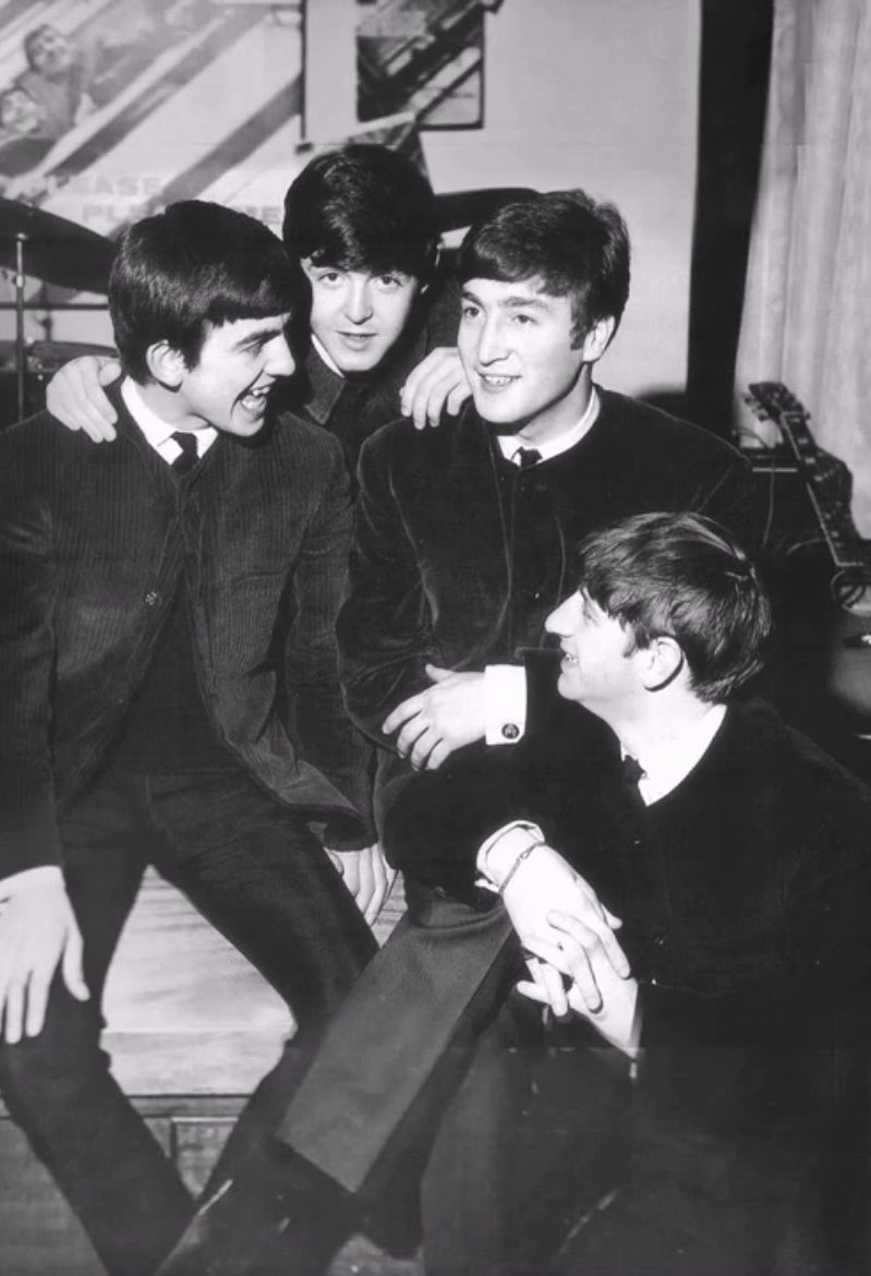 The Beatles at a lunchtime ceremony at EMI House, where they received their first silver disc award from their producer, George Martin, for sales of over 250,000 copies of their single "Please Please Me", 5 April 1963