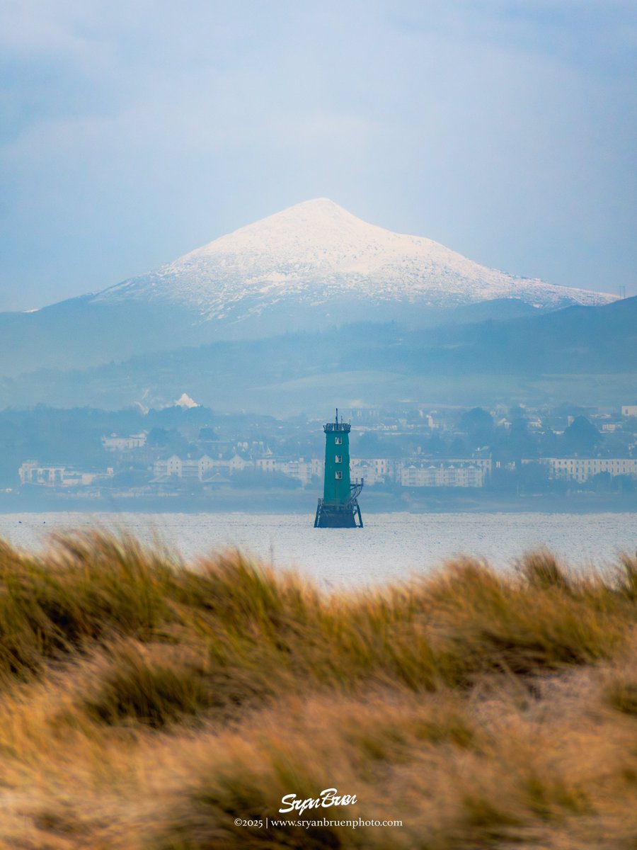 Additionally with the Poolbeg Lighthouse, I got the snowy Sugar Loaf lined up with North Bull Lighthouse on Wednesday afternoon although not perfectly symmetrical. The sand dunes in the foreground are blurred from the zoom compression. Not "photoshop".
