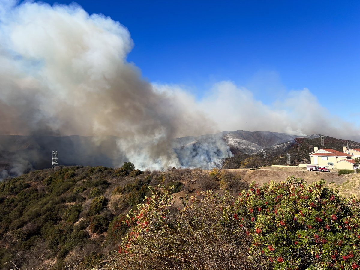 View from Mountain Gate just east of Mandeville Canyon. Fire slowly moving closer to homes here. Planes doing lots of fire retardant drops.