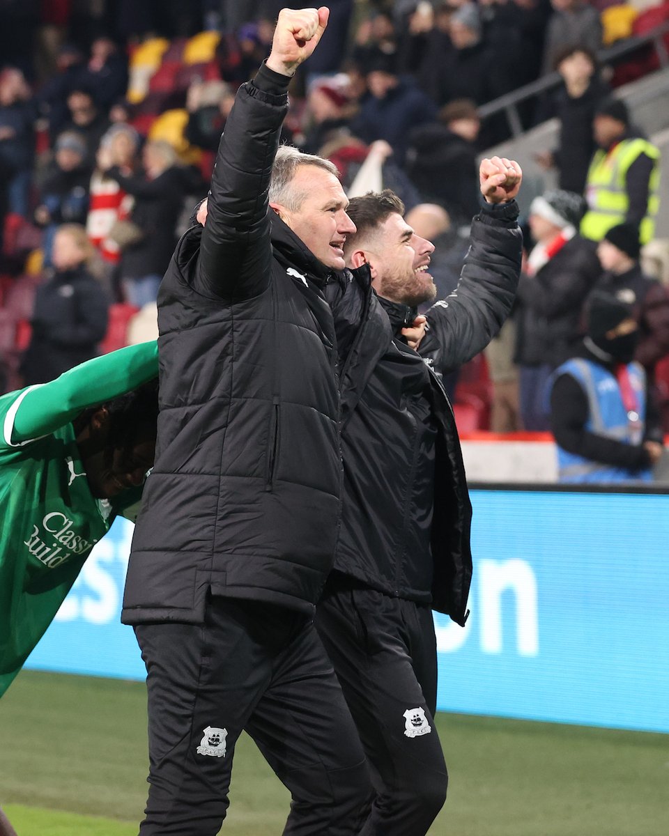 Kevin Nancekivell and Joe Edwards celebrating after full-time at Brentford.