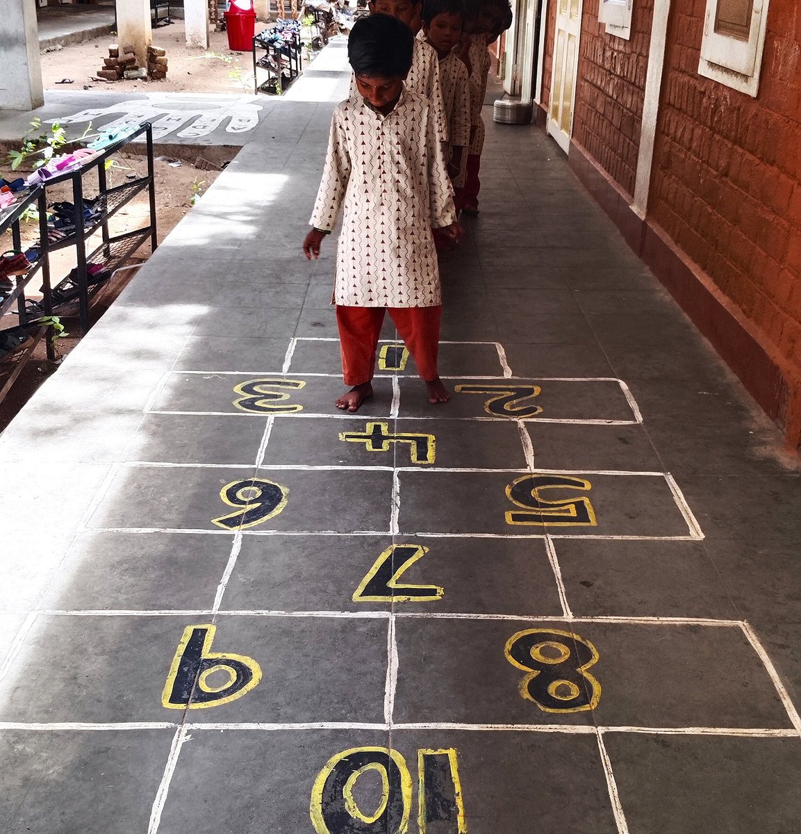 ishavidhya's tweet photo. Merging Visual Learning in Everyday Spaces
Veranda floor drawings of numbers, shapes, and measurements at Isha Vidhya Villupuram helped the Class 1 students learn the lesson and review it in passing. Learning became interactive and engaging and was woven into their daily routines https://t.co/ADKkB1dr1M