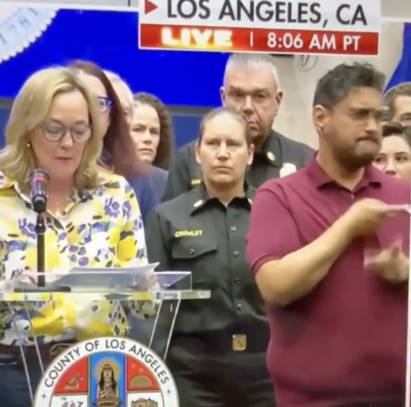 JohnLeFevre's tweet photo. Government officials are all over TV reassuring people that they are competent and are using our resources wisely... 

Standing next to them are sign language interpreters, who were made redundant by technology 20 years ago. https://t.co/s0cPqWd4Gu