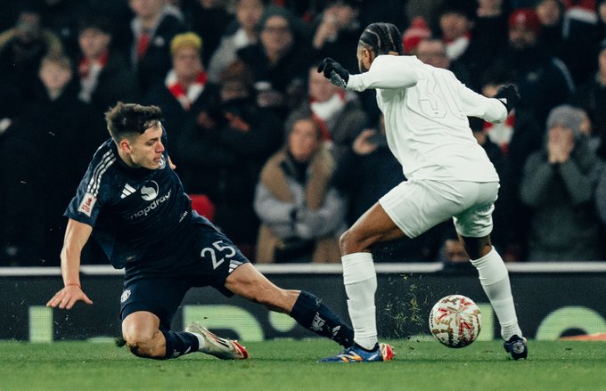 Manuel Ugarte attempts to tackle Raheem Sterling.