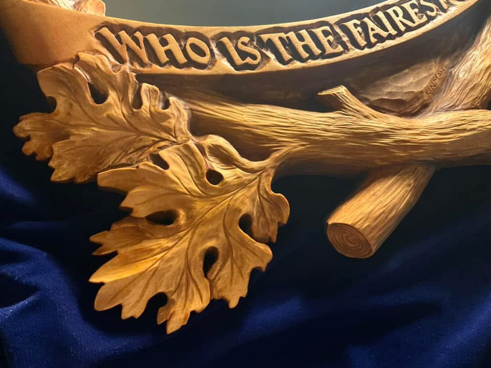 Raymond_Kinman's tweet photo. This hand carved mirror frame has a story to tell.  There’s four parts to it…

Part One - Opening Scene: 
This mirror frame was created as an original commission I carved back in the mid-90s. Recently, the client reached out to see if I could repair it…it had been badly damaged during a move and when it arrived at my studio it was in five pieces.

Sigh.

Part Two - The Restoration:
It was touch and go, but I managed to piece it back together. However, the damage was so extensive it became clear to me that I’d have to completely re-carve the entire frame. It needed it anyway….after all, I’m a better woodcarver now than I was in the 90s, so I gave it a fresh, updated life.

Part Three:  A New Chapter:
The first piece in a new signed, limited edition series of this mirror frame is on my workbench right now. I’m keeping the first one (#1 of 195) as Marisa’s Valentine’s Day gift (yes, she knows!). Hers in the lower-right photo.

Part Four:  The Plot Twist:
Check out the Valentine heart carved into the branch bark on the left side, much as young lovers might do, complete with initials.

For the original commission, the client requested the iconic phrase from Snow White without the question mark: “Who is the Fairest One of All.”

For Marisa’s mirror, I made a change.  Hers says: “The Fairest One of All.”

#SnowWhite #Disney #Woodworking