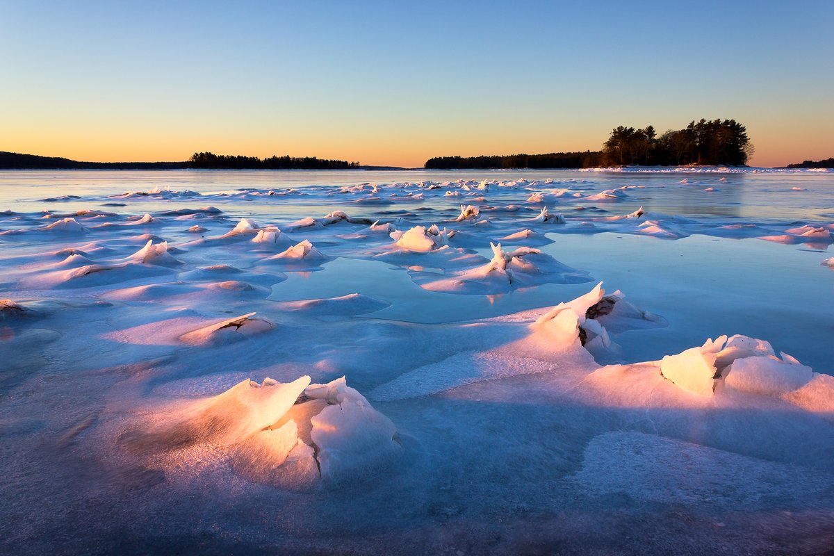Ice settling onto boulders at low tide in Middle Bay, Brunswick, Maine