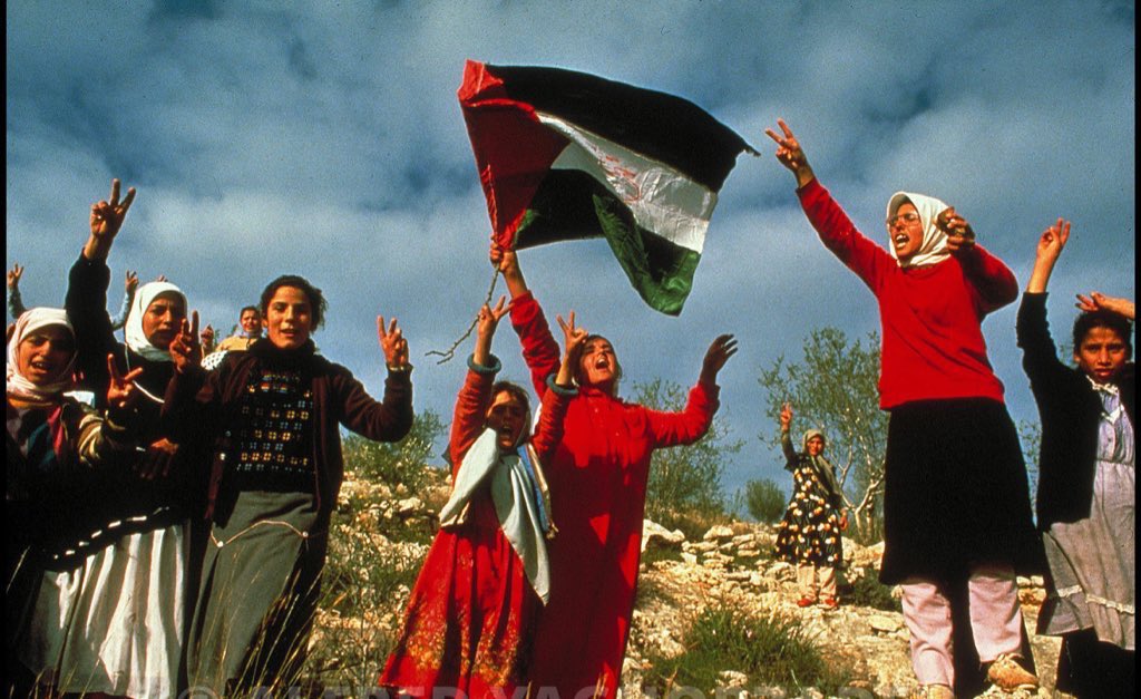 Palestinian girls in Beita, Nablus holding a hand sewn flag during the first intifada (1988)