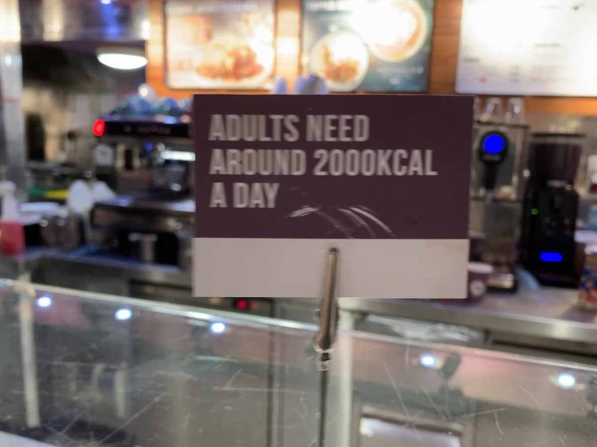 ShonaCWatt's tweet photo. What does everyone think of this sign strategically placed above the cake counter @SOHO_Coffee_ ? This was in #Bristol but seen it elsewhere so must be standard issue. #NHS #obesity https://t.co/9kCYFbzYvn