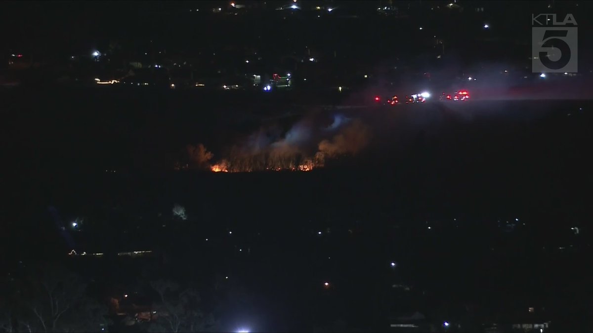 KTLA's tweet photo. #BREAKING: Firefighters are battling a new #wildfire in #RiversideCounty. Sky5 is overhead with a view of the flames in #JurupaValley. LIVE: https://t.co/ZmHfbaBqrp https://t.co/PiX5eWuJGN