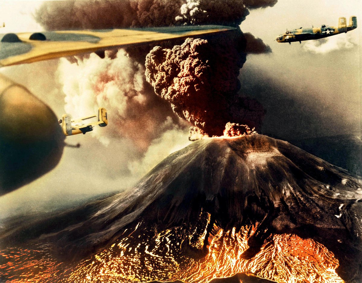 B-25 Mitchell bombers of 321st Bomber Group, 447th Bomber Squadron flying past #MountVesuvius, Italy, during its eruption between 18-23 Mar 1944. The same Mount Vesuvius erupted in 79 AD and buried the Roman cities of Pompeii and Herculaneum under layers of rock and ash. #WW2