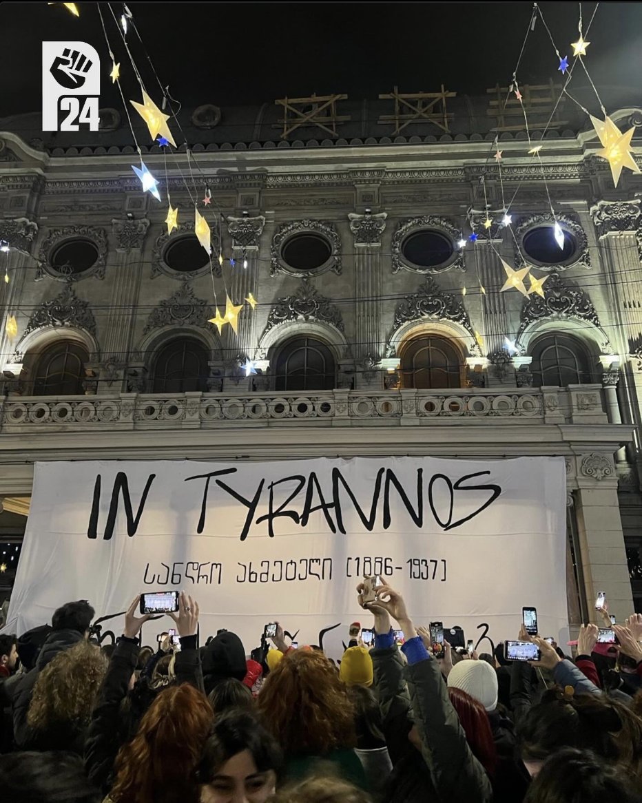 KShoshiashvili's tweet photo. #Tbilisi Now: A banner referencing Sandro Akhmeteli, a prominent Georgian theatre director executed during the Stalinist purges in 1937, has been reinstalled on the façade of the Rustaveli Theatre. The banner features the title of Akhmeteli's play, In Tyranny's Opposition, which was banned following his execution.

This act of resistance comes in the wake of the recent arrest and continued detention of Andro Chichinadze, a colleague of the organizers, and other political prisoners. On January 10, the oligarch-controlled court extended their pretrial detention. By reviving Akhmeteli’s legacy, the organizers sought to draw attention to the enduring fight against oppression and the resilience of those who resist tyranny, both past and present. Photo: @protest_24