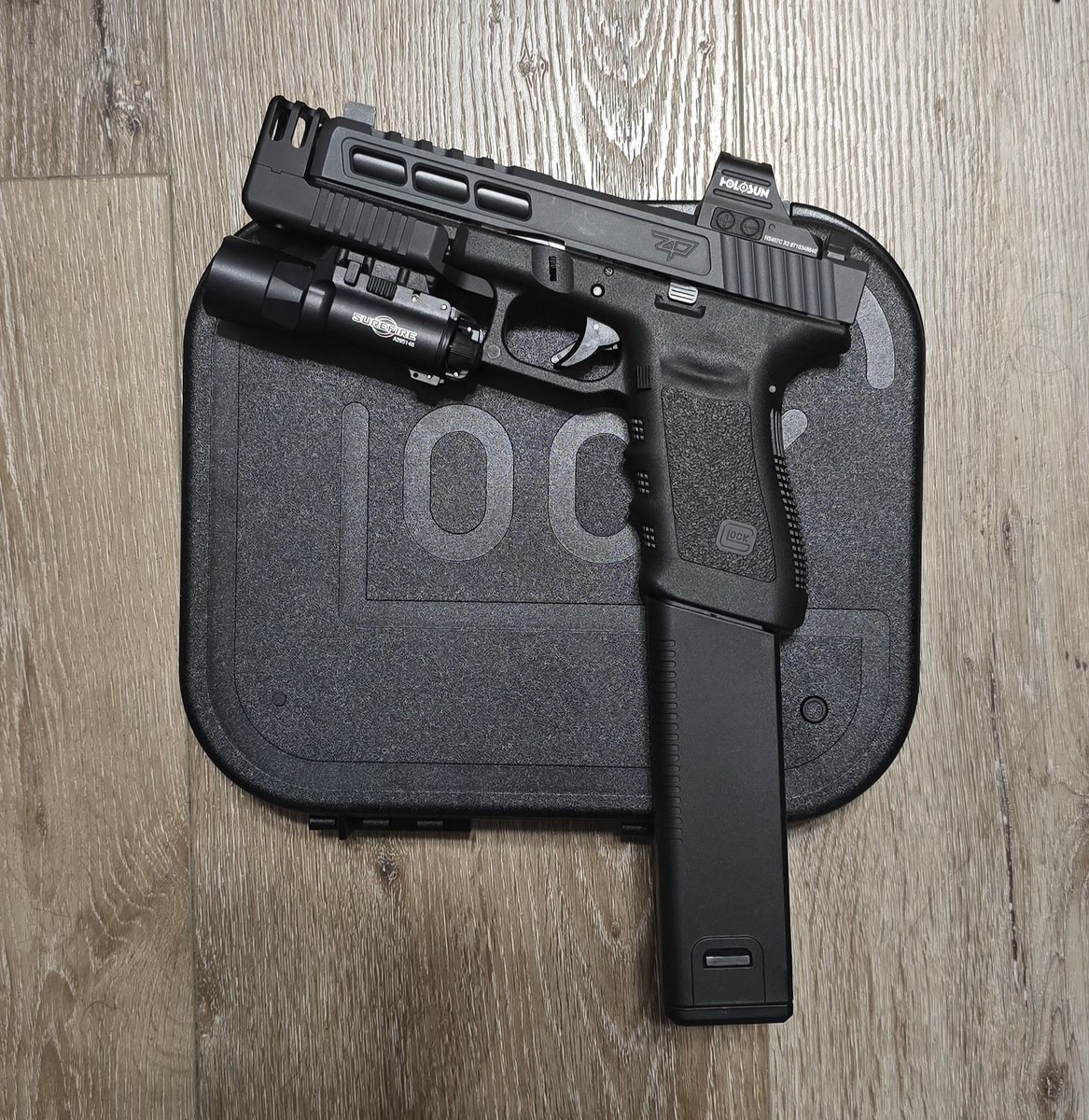 One of my hobbies. My custom 10mm Glock 20SF Gen 3. Zaffiri Custom Slide. Compensated Stand Off Device. Surefire X300-A light. Holosun 407C Optic. Kriss Extended Magazine. 10mm, in case I have to defend myself against bears or stupid people lol