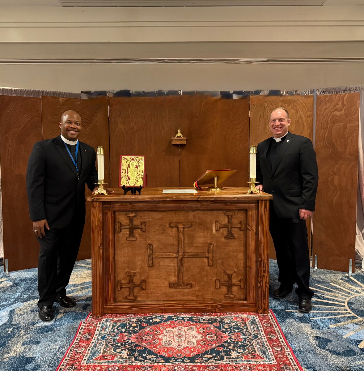 Fr Lawrence McElrath and Fr Jeramy Jensen present a new, portable, Provincial altar and reredos at the College of Bishops. Having made them themselves they then drove them to the meeting of the College of Bishops in Melbourne, FL from Colorado. Thank you. All are appreciated!