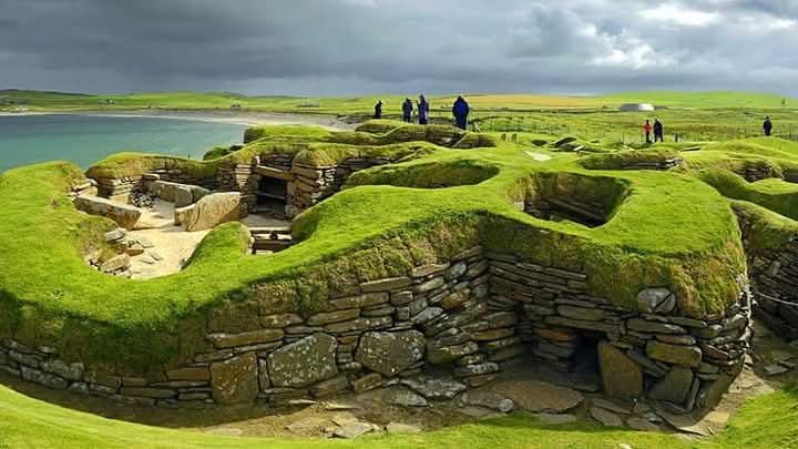 histories_arch's tweet photo. Predating Stonehenge and the pyramids of Giza, extraordinary Skara Brae is one of the world's most evocative prehistoric sites. Consisting of ten stone structures, near the Bay of Skaill, Orkney, Scotland, it is northern Europe’s best-preserved Neolithic village. 

Even the stone furniture – beds, boxes and dressers – has survived the 5000 years since a community lived and breathed here, giving an incredible insight into everyday Stone Age life.

Today the village is situated by the shore but when it was inhabited (3100-2500 BC) it would have been further inland. Steady erosion of the land over the centuries has altered the landscape considerably and interpretations of the site, based upon its present location, have had to be re-evaluated in light of this. 

The name `Skara Brae' is a corruption of the old name for the site, `Skerrabra' or `Styerrabrae' which designated the mound which buried (and thereby preserved) the buildings of the village. The name by which the original inhabitants knew the site is unknown. 

Idyllically situated by a sandy bay 8 miles north of Stromness, the Unesco-listed settlement was hidden until 1850, when waves whipped up by a severe storm eroded the sand and grass above the beach, exposing the houses underneath. It can feel as though the inhabitants have just slipped out to go fishing and could return at any moment.

#archaeohistories