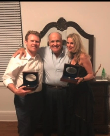 EndureFlourish's tweet photo. As Andrew and Rudy Giuliani fight to keep the WS rings, ask yourself:  
Why isn't Andrew's wife, pictured here at the purported gifting event, being called as a witness? https://t.co/Igger8SIGh