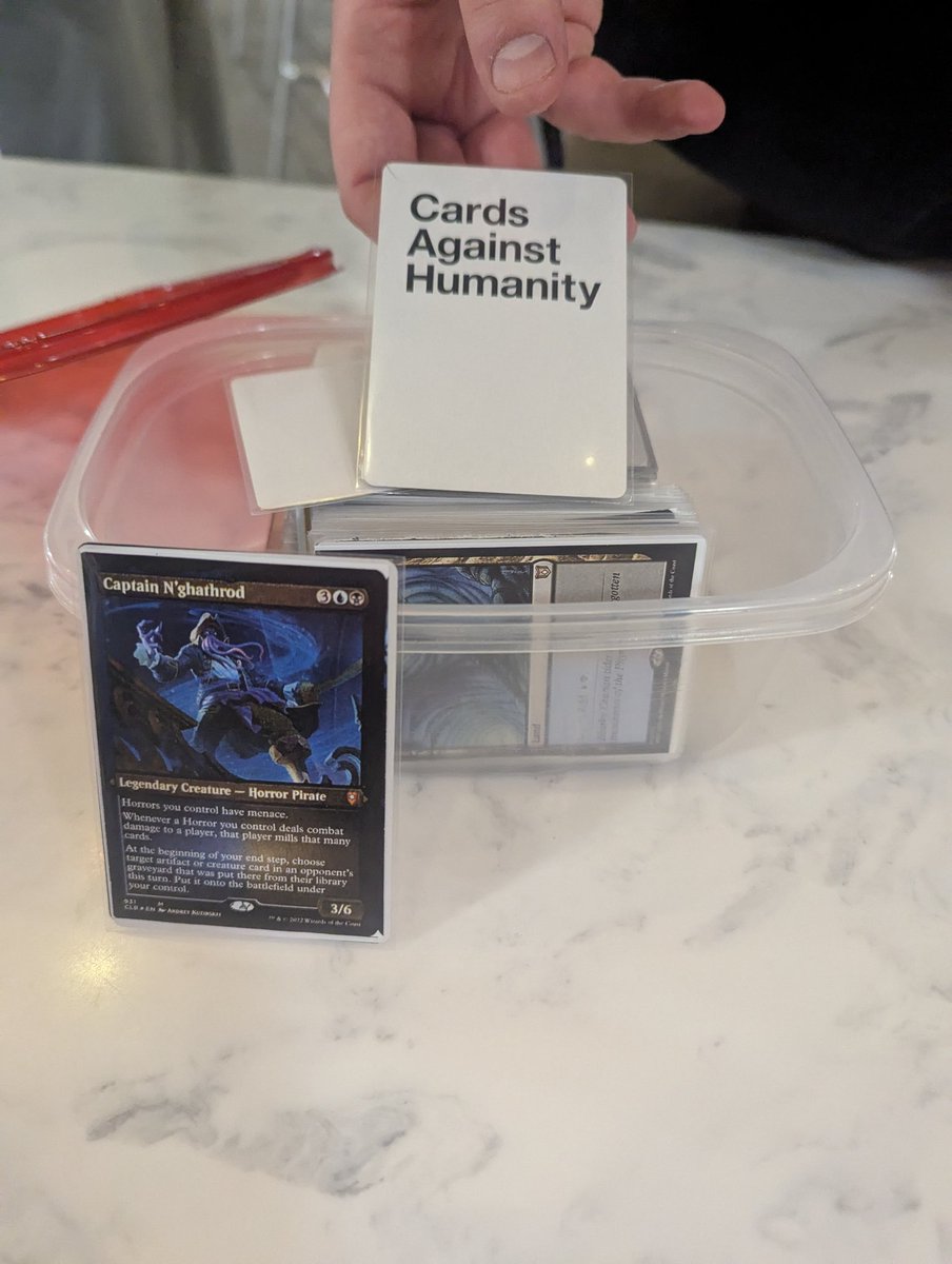 So I work at a university now and I played commander with two of my students. They both proxied their entire decks and I lost to his captain N'Gathroddeck. However, the best part is what he used for backers and a deck box...