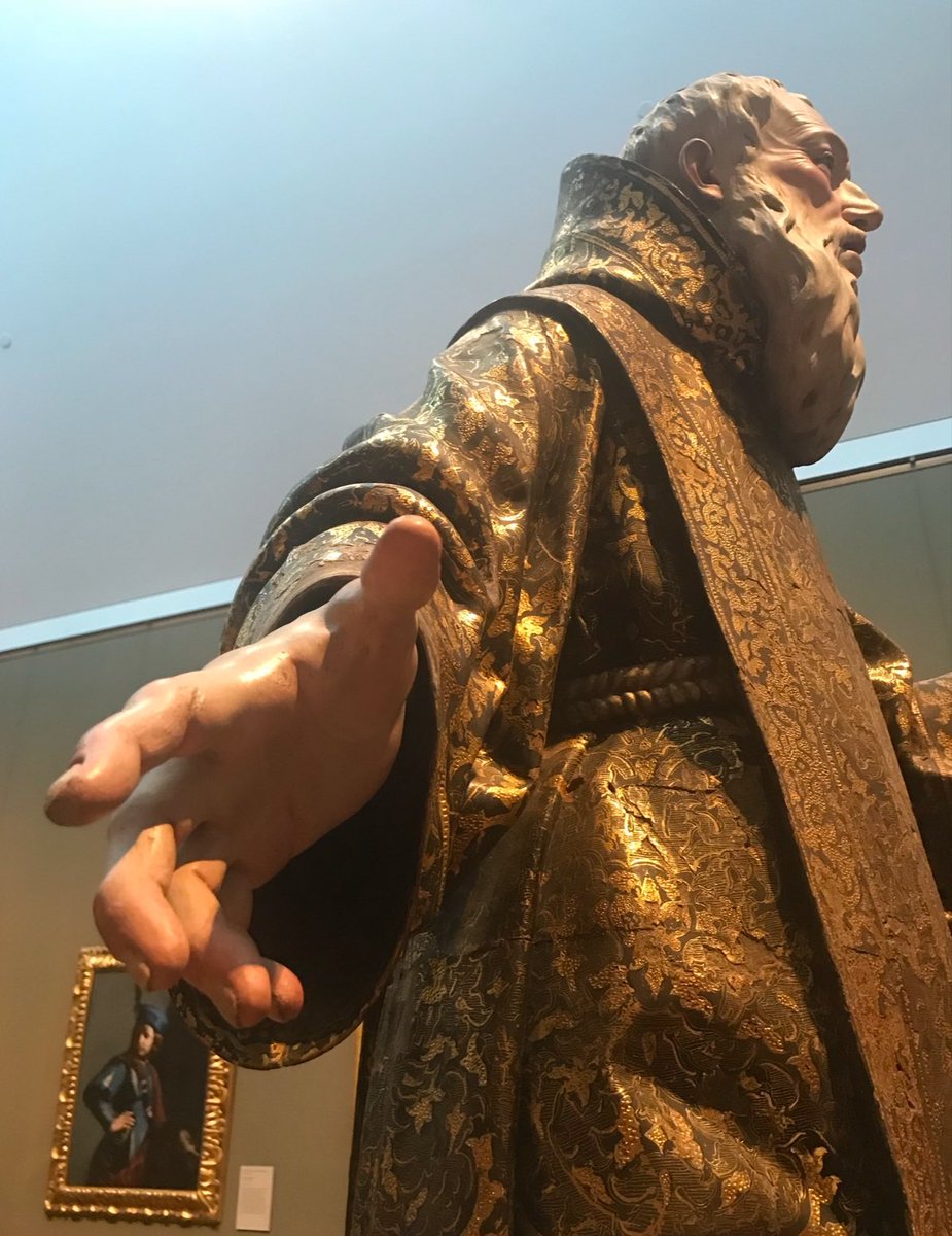 Raymond_Kinman's tweet photo. We saw this astonishing carved wood statue of St. Gines de la Jara at the Getty Museum, and it completely took my breath away.  The details were so stunning, so lifelike….the museum information plaque didn’t include many details, so I wanted to know more about the artist who created this incredible carving.  

As it turns out, this statue was carved in 1692 by….

Wait for it….

A woman?

It’s true.  This incredible piece was carved by Luisa Roldán, or La Roldana, a 17th-century Spanish sculptor who broke barriers as the first female court sculptor for the kings of Spain.  In the 17th century, women weren’t accepted as professional artists because society expected them to stick to domestic roles like running a household and raising children. 

Training opportunities were scarce; women were often barred from workshops, guilds, and art academies, and they couldn’t study crucial subjects like anatomy, because it was considered “inappropriate” for a woman. 

Sculpture, in particular, was considered too physical for women, and most patrons preferred commissioning men, assuming women lacked the skill and/or professionalism. 

La Roldana defied all of that. She learned carving in her father’s workshop, honed her craft, and ultimately became the first female court sculptor to the kings of Spain.

Despite her obvious genius, Roldán lived much of her life in poverty, even as the court sculptor.  She struggled financially despite her immense talent.  This was partly because, even at the highest levels, artists of her time were often underpaid or faced delays in receiving payment for commissions. Additionally, as a woman, she faced extra hurdles in gaining consistent and lucrative work, as patrons consistently favored  male artists.

Although she held a prestigious position, the court often failed to pay her regularly or adequately. Combined with the lack of a strong support system and her limited ability to advocate for herself in a male-dominated field, these factors left her in a state of near poverty throughout much of her life.

She was a master of polychrome sculpture, carving figures out of wood and bringing them to life with layers of intricate paintwork. Using a technique called encarnación, she created the illusion of translucent, living skin, even painting delicate blue veins beneath the surface. To heighten the realism, the statue also features glass eyes, which catch the light, making the figure feel almost alive.

What’s really striking is her use of exaggeration. Hands and feet are really difficult to carve.  The slightly oversized hands and feet of St. Gines amplify the emotional intensity and presence of this piece, right down to the tiniest details such as the toenail fungus.  Notice how the knuckles are a tiny bit larger than in real life.

It appears to me that at one time this dude may have been holding something in his left hand but I couldn’t find any information about that.
#BaroqueArt #Sculpture #ArtHistory #WomenInArt #GettyMuseum #LaRoldana #SpanishArt #WoodSculpture #PolychromeSculpture #FemaleArtists