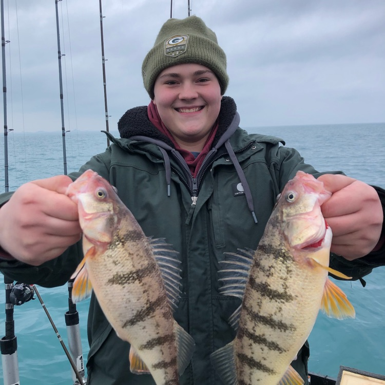 TinleyParkHigh's tweet photo. Over winter break, Mr Robson and the Fishing Club ventured out onto frigid Lake Michigan. Tristan and Connor caught these giant Perch! #TPTitanNation https://t.co/pOaGBEFENq
