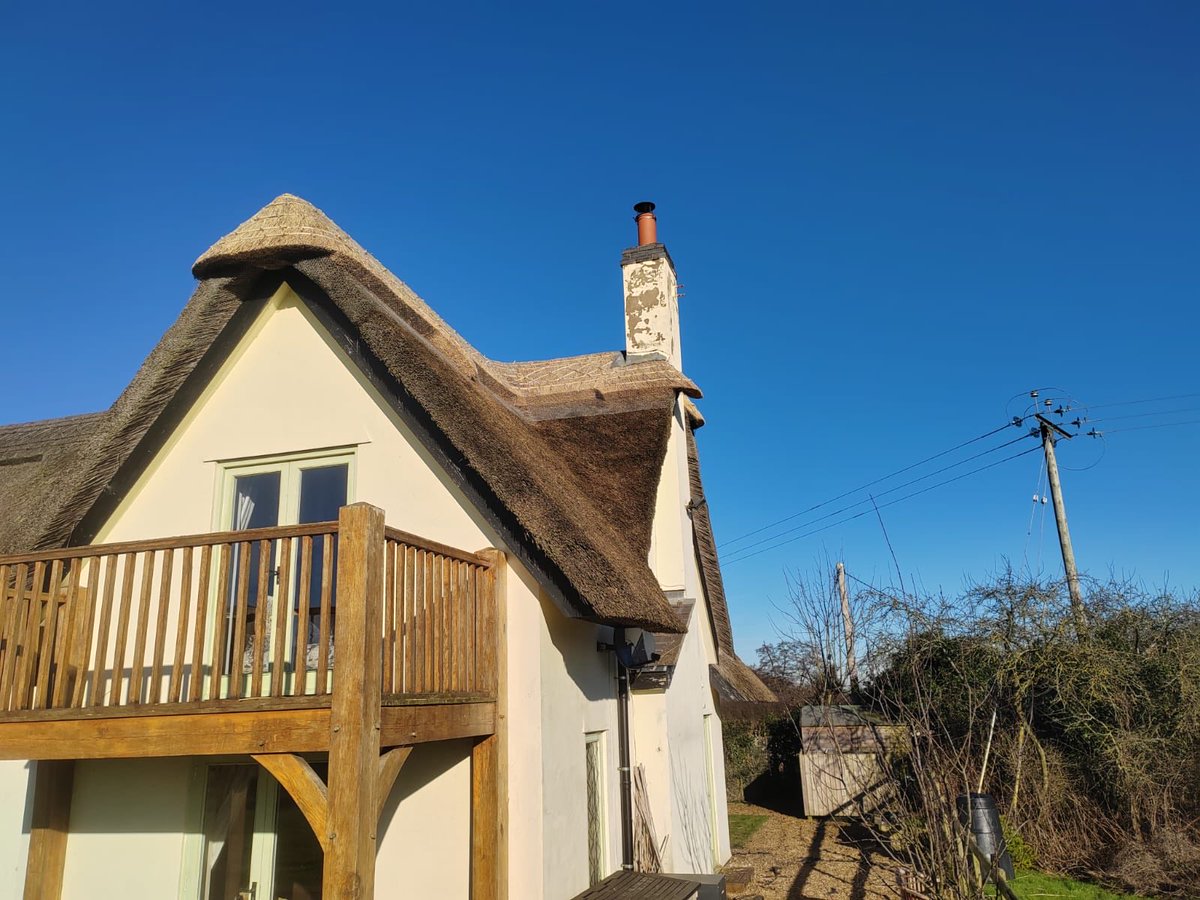masterthatcher2's tweet photo. Blue skies are back! This small re-ridge is near #Tarporley in #Cheshire. Unfortunately the chimney was too wet to paint as a favour for the client.. #Thatching. https://t.co/XmID9E1ZjY